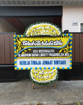Papan Bunga Duka di Piani